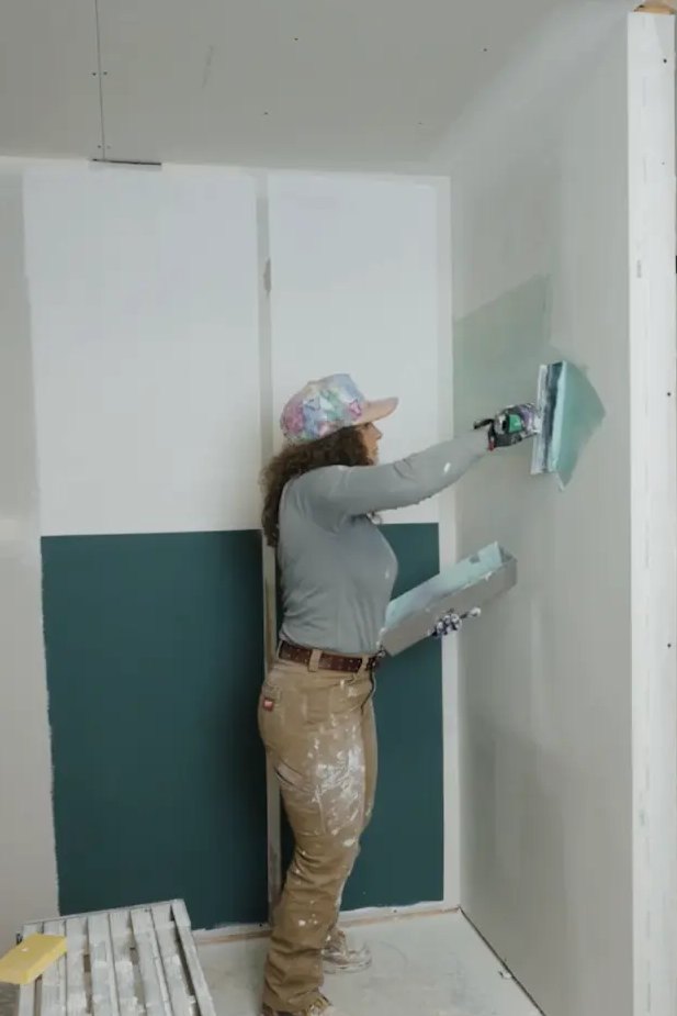 Lydia skimming a wall with a wide knife